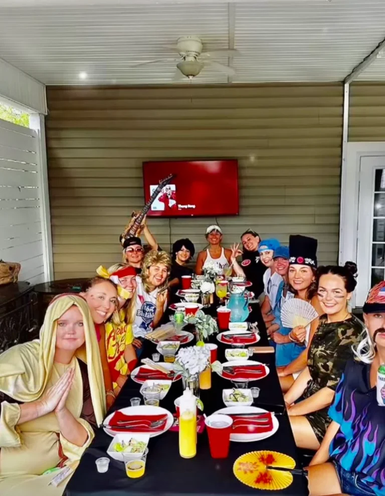 A group of people dressed in various costumes seated around a table, ready for a private Hibachi experience.